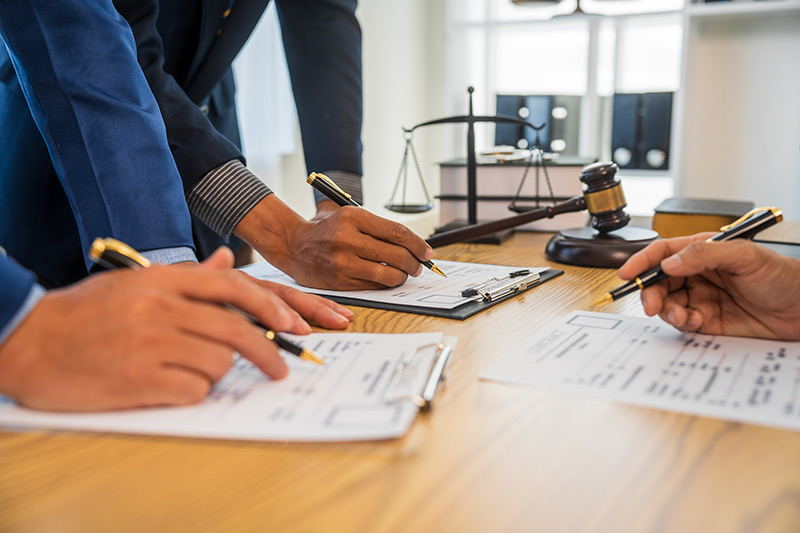 Arbitrator reviewing documents during a UM/UIM insurance dispute hearing