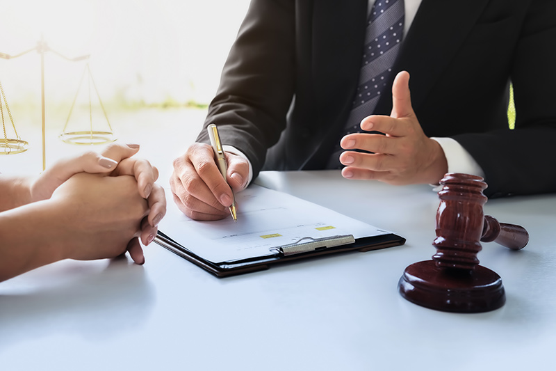 Lawyer filling out paperwork for an administrative claim regarding road-related injury