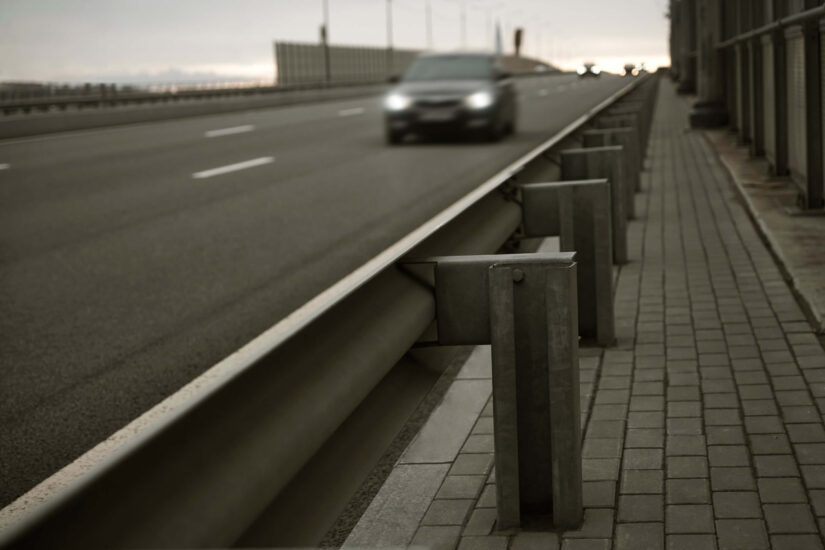 Car on highway next to a guardrail