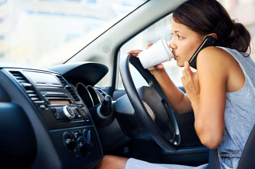 Businesswoman multitasking while driving