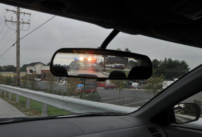officer standing by a car during a traffic stop